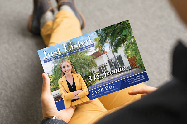 man in a suit holding a leader in print business card